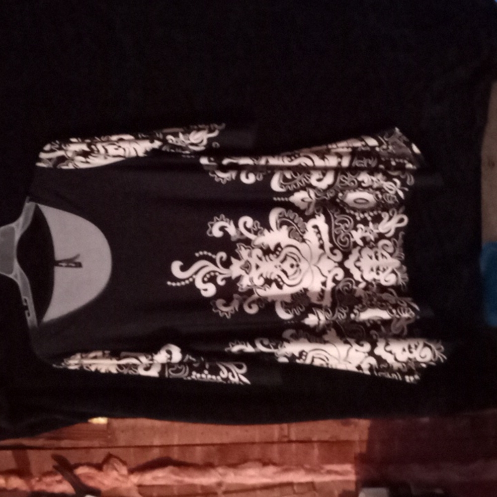 Black and white blouse made of polyester and spandex. It is a 2XL.